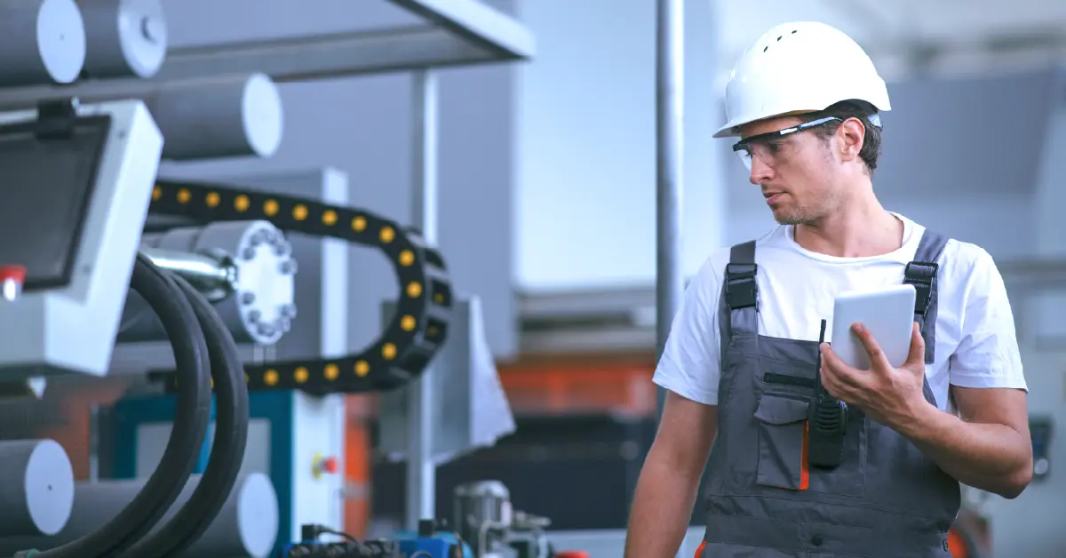 Connected worker in a factory exploring ways to reduce manufacturing costs